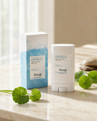 Silky-Fit Sun Stick SPF50+ overhead flat-lay with centella and pebbles