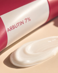 Close-up of the brightening cream texture swatched beside the tube
