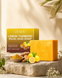 Turmeric and kojic acid glow bar soap with box on a stone pedestal in warm light